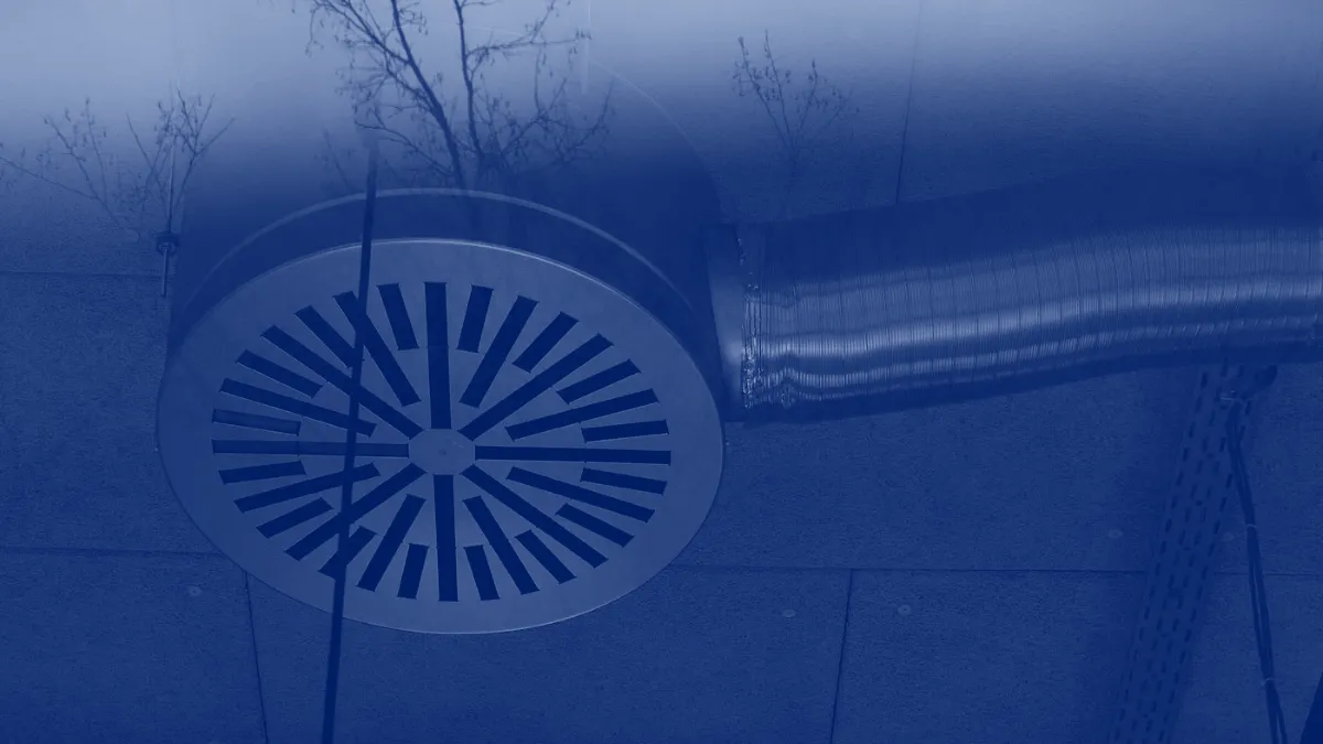 Difusor circular de aire acondicionado en el techo de un edificio